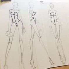 three sketches of female mannequins on paper