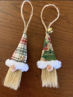 two small christmas hats hanging from twine