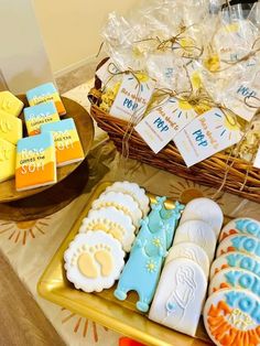 some cookies are on a table near a basket full of candy and other items for sale