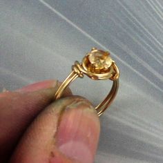 "THE BEAUTY OF YELLOW CITRINE 14kt rolled gold RING HOLDING A 6MM YELLOW CITRINE Pictures do not show the true beauty of the STONE made to size ----- custom hand crafted setting Size 5 to 8 (see chart) In a sculpted one of kind handcrafted 14kt rolled gold setting ABOUT MY JEWELRY This is wire sculpted Jewelry all made by hand. It is created wire by wire with the best metals and material in the business. Such as Sterling Silver, and precious stones, and 14kt rolled gold.Gold. Each item is a smal Adjustable Gold Solitaire Jewelry, Gold Citrine Promise Ring, Gold Rings With Birthstone For Jewelry Making, Gold Citrine Ring With Prong Setting, Gold Citrine Rings With Prong Setting, Gold Citrine Birthstone Ring For Promise, Gold Citrine Birthstone Promise Ring, Adjustable Gold Birthstone Ring With Prong Setting, Gold Citrine Birthstone Ring With Prong Setting