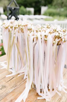 the table is covered with white ribbons and pink flowers, along with black starburst centerpieces