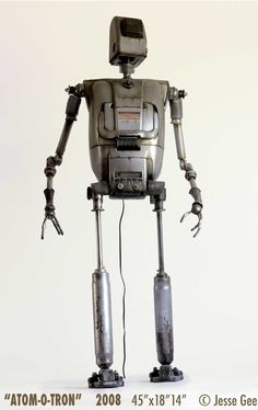 a robot is standing in front of a white background with the caption'tom - o - tron'on it