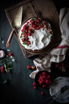 a cake with white frosting and strawberries on top