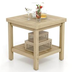 a small wooden table with two baskets on it and some drinks in the glass holder