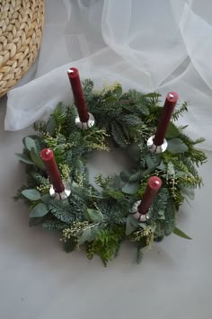 a wreath with three candles on top of it