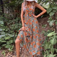 Beautiful Top Knot Cami Maxi Bottom Tier For Flare Front Top Knot In Cleavage Ruched & Ruffled Cami Straps Large Blue Orange & Green Floral Pattern Perfect To Relax At A Bbq/Block Party Beach Day! Orange Boho Print Maxi Dress For Summer, Orange Sundress For Beach Season Brunch, Orange Sundress For Brunch And Beach Season, Orange Sundress For Brunch During Beach Season, Orange Boho Print Maxi Dress For Beach, Orange Boho Print Maxi Dress For Vacation, Orange V-neck Sundress For Beach Season, Casual Orange Dresses For Beach Season, Orange Bohemian Sundress For Beach Season