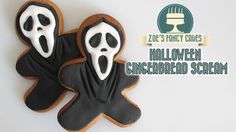 two decorated cookies in the shape of ghostes with white icing and black icing