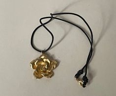 "Matte gold, satin gold rose pendant, black cord  Excellent condition  all sizes approximately: flower diameter - 1 7/16\"  cord - 19 1/4\"  Unmarked  09/13/23 1565" Gold Rose Pendant, Adjustable Gold Rose Design Jewelry, Rose Pendant, Gold Satin, Rose Necklace, Jewelry Lookbook, Necklace Black, Cord Necklace, Silver Roses