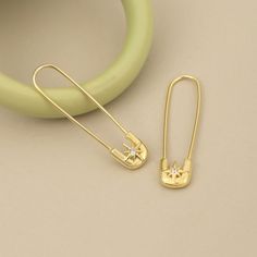 a pair of earrings sitting on top of a table