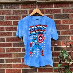 This Is Brand New With The Tags! Please Comment If You Have Any Questions! I Believe That This Fits Smaller Multicolor Short Sleeve T-shirt For Disney Trips, Multicolor Short Sleeve T-shirt For Disney Fans, Disney Fan Apparel T-shirt With Short Sleeves, Disney Short Sleeve Pre-shrunk T-shirt, Captain America Shirt, Captain America Tshirt, Blue Tie, Blue Tie Dye, Disney Trip