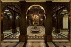 an ornate hall with chandeliers and marble flooring is pictured in this image