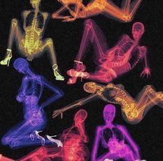 an image of some neon colored skeletons in the dark