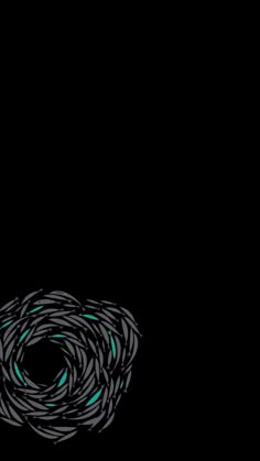 a black background with blue and green swirls in the center on top of it