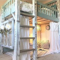 the bunk bed is made out of wood and has curtains hanging from it's sides