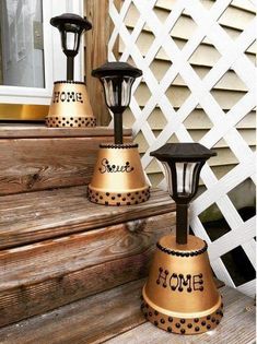 three black and gold lanterns sitting on the steps