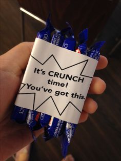 someone is holding up a candy bar wrapper that says it's crunch time you've got this