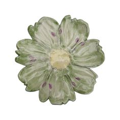 a green and white ceramic flower on a white background