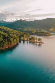 an aerial view of a lake surrounded by trees