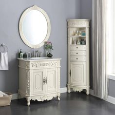 a bathroom with a sink, mirror and cabinet next to a window in the room