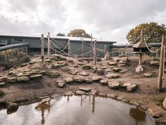 an outdoor play area with water and rocks