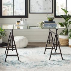 a living room with two windows and a rug on the floor in front of it