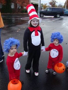 three children dressed up as dr seuss and the cat in the hat with pumpkins