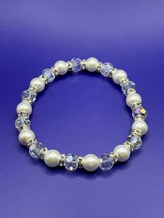 Elegant accessory to your winter (or bridal) look. A stretch bracelet with white pearl-like glass beads with clear rondelle beads and silver rhinestone spacer beads. Bridal Look, Elegant Accessories, White Crystal, Silver Rhinestone, Winter White, White Pearl, Bridal Looks, Stretch Bracelet, Spacer Beads