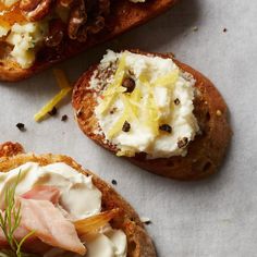 three pieces of bread with different types of food on them and some garnish