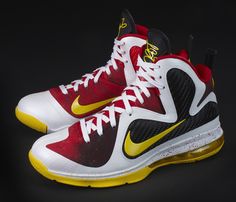 a pair of nike shoes with yellow and red accents on the upper part of the shoe