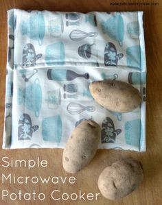 two potatoes sitting on top of a table next to a cloth covered with an oven mitt