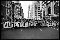 a crowd of people holding up a banner