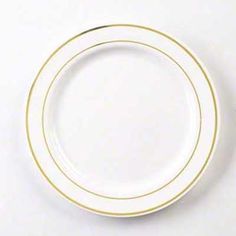 an empty white plate with gold rim on a white tableclothed surface, ready to be used as a place setting