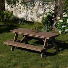 a picnic table with two benches in the grass