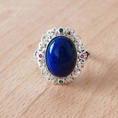 We only sell handmade jewelry made of solid 925 silver,gold plated.Here is the information of this ring. Metal:S925 Silver Main Stone:Lazurite Side Stone:Cubic Zirconia Main Stone Size:10mmx14mm Width of band:2mm Weight:4g Packed in an exquisite ring box Adjustable Size from 53mm-58mm(US size 6-8 1/2) Each stone has different characteristics, such as shape, color, texture, and spots. These are common features of natural stones, not flaws. I hope you can understand.  Tips for Storing Sterling Sil Handmade Oval Lapis Lazuli Rings, Oval Lapis Lazuli Rings For Gift, Handmade Silver Jewelry, Lapis Lazuli Ring, Wooden Jewelry Boxes, Silver Jewelry Handmade, Women Ring, Blue Gemstones, Ring Handmade