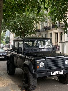 a black jeep is parked on the side of the street