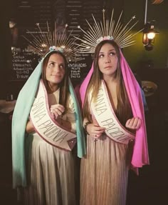 two young women dressed in costumes standing next to each other