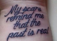 a wrist tattoo saying my scars remind me that the past is real