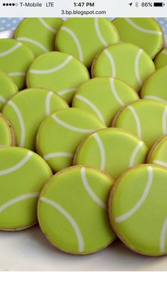 a white plate topped with green and white tennis cookies