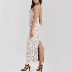 Elevate your wardrobe with this captivating bodycon maxi dress, perfect for making a lasting impression. The dress features delicate white lace-up details and exquisite floral embroidery, blending modernity with romantic elements. Spaghetti straps lend an airy and sophisticated look, while the back split provides both style and practicality. Whether attending a wedding, an upscale dinner, or a fashionable gathering, this dress ensures you’ll stand out in refined elegance. Color: WhiteNeckline: S Feminine Delicate Lace Dress For Brunch, Elegant Spring Lace Dress For Prom, Elegant Lace Dress For Spring Prom, Elegant Lace Prom Dress For Spring, White Summer Dresses With Lace Back, White Summer Dress With Lace Back, White Lace Back Summer Dress, Feminine Delicate Lace Midi Dress For Parties, Spring Floral Embroidered Maxi Dress For Prom