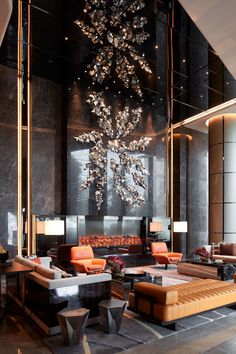 an elegant lobby with modern furniture and chandelier