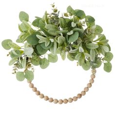 an arrangement of green leaves and beads on a white background