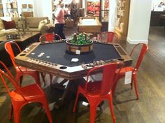 a game table with chairs around it in a room filled with furniture and other items