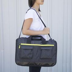 a woman carrying a black and yellow bag