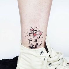 a small cat tattoo on the ankle