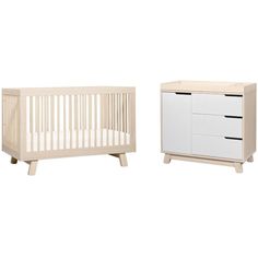 a baby crib and dresser are shown in this image, both white with black handles