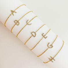 This Dainty Sparkle Initial Bracelet adds a touch of sparkle and personalization to your look. Crafted with a slim and dainty chain, the adjustable sliding closure makes it easy to put on and get the right fit. Perfect for wearing alone or layering with other bracelets, it adds just the right amount of sparkle.Reversible with plain gold side or sparkly CZ side.Approximately, can fit up to 9 inch perimeter18k gold plated Stainless Steel, tarnish and water resistantCubic ZirconiaLead and Nickel fr Bracelet Initial, Hair Setting, Dainty Chain, Initial Bracelet, Scrunchie Hairstyles, Steel Jewelry, Headband Hairstyles, Hair Accessories Headbands, Stainless Steel Jewelry