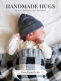 a baby laying on top of a blanket covered in a black and white checkered blanket