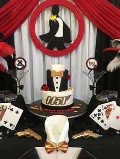 a table topped with a cake and casino themed decorations