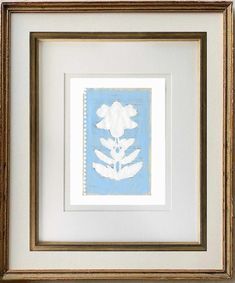 a white flower in a gold frame on a blue and white background with an old - fashioned border