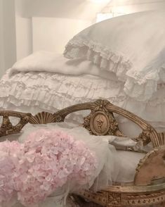 a white bed with pink flowers on it